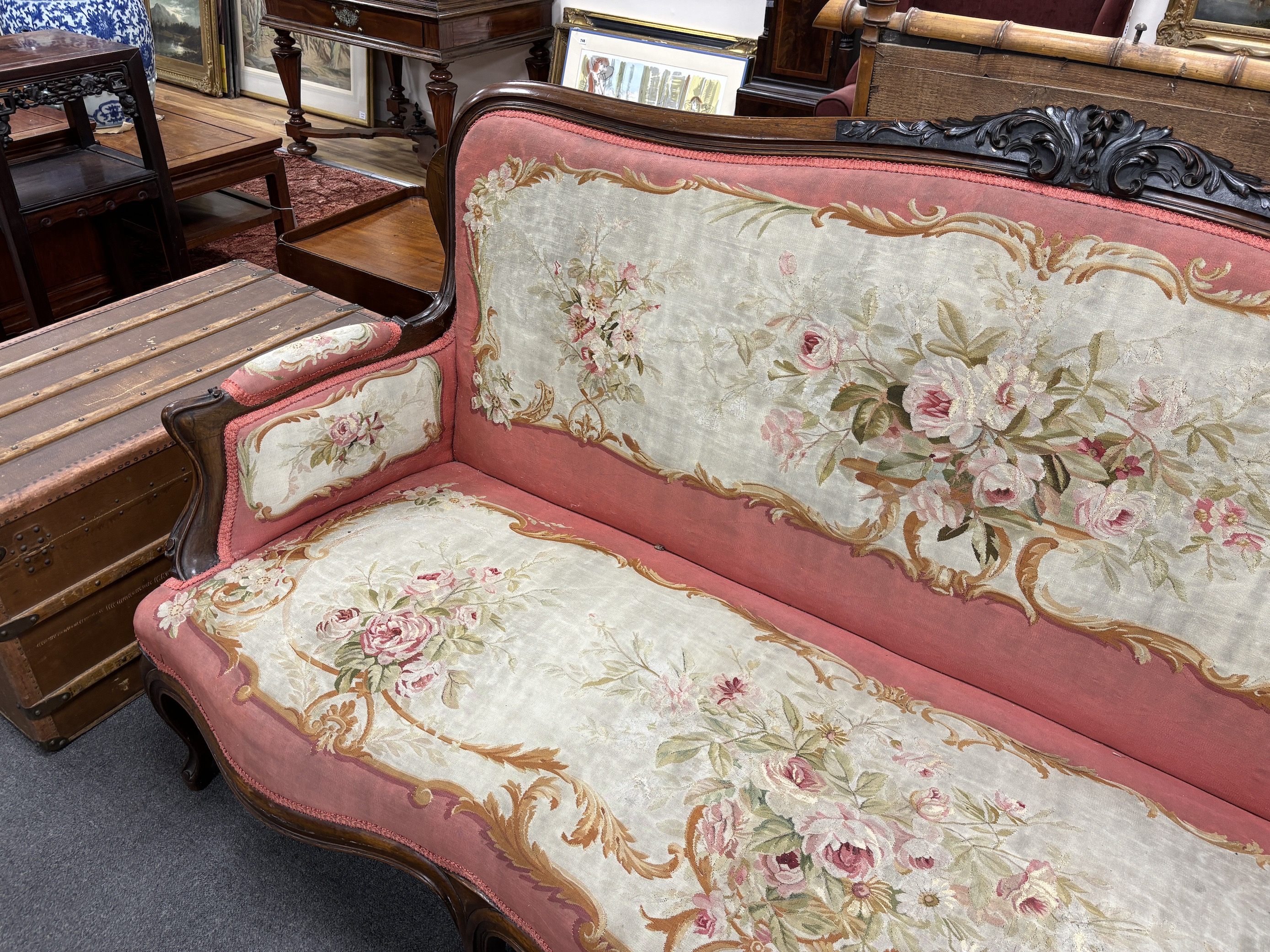 A 19th century French rosewood settee with floral needlepoint upholstery, width 198cm, depth 66cm, height 108cm